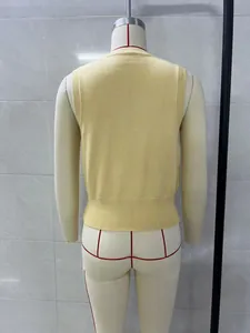 Sleeveless yellow knitted top for women showing back view detail on professional mannequin