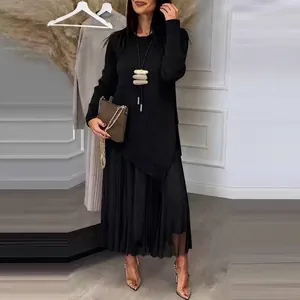 Elegant black long sleeve knit top with asymmetrical hem and matching pleated skirt set