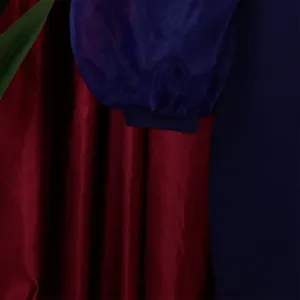 Detail of elegant sheer mesh balloon sleeves on a dark blue long sleeve pencil dress.