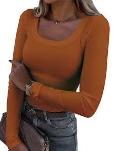 Close-up showing the soft ribbed fabric and slim-fit tailoring of this orange long-sleeve top.
