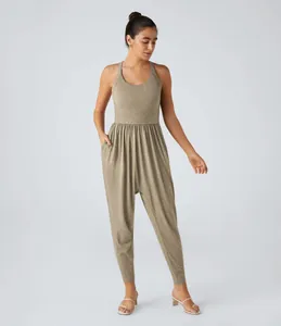 Detailed shot of women's khaki casual jumpsuit featuring a drop crotch and side pockets
