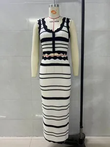 Detailed view of women's striped knitted two-piece set with crop top and high-waist skirt