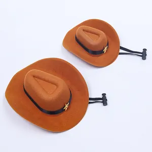 Pair of brown miniature pet cowboy hats with adjustable elastic straps and gold stars