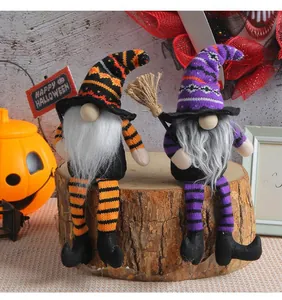 Detailed view of two handmade Halloween witch gnomes sitting on a rustic wooden stump