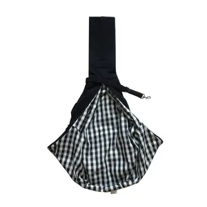 Close-up of pet sling carrier showing the breathable black and white gingham lining