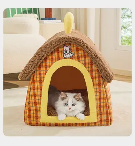 Cozy orange plaid indoor pet house with brown plush roof and a cat resting inside