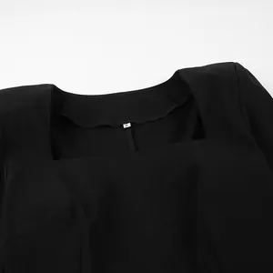 Detail view of square neckline on elegant French style black dress with size M label