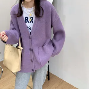 Detail view of a soft purple oversized knit cardigan with V-neck and front pockets.