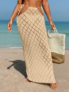 Detailed view of beige crochet maxi skirt with hollow diamond pattern and side ties.