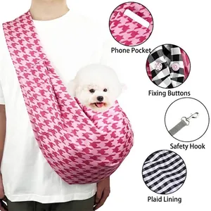 Pink houndstooth pet sling carrier bag with phone pocket and interior safety buckle