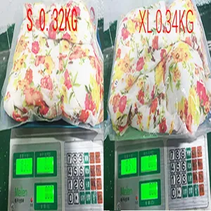 Detailed view of floral chiffon maxi dress on scale for shipping weight verification