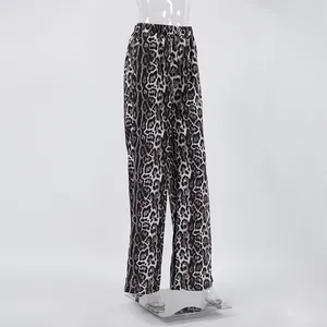 Detail of trendy leopard print high-waisted wide-leg trousers with elastic waist for women