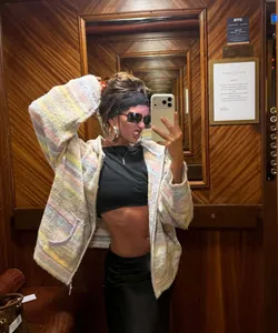Cozy multi-colored striped hooded knit cardigan shown in a stylish mirror selfie