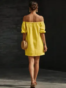 Back view of yellow off-shoulder cotton linen summer mini dress in outdoor lighting