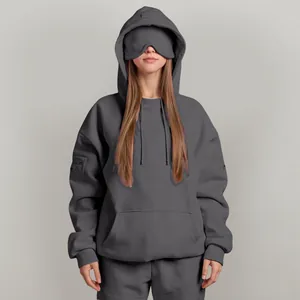 Detail view of grey hoodie featuring a unique built-in eye mask design for travel comfort