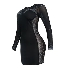 Detail view of a black bodycon dress featuring rhinestone mesh and sheer mesh paneling