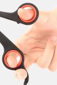 Close-up of ergonomic pet nail clipper handle with red non-slip rubber finger loops