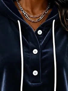 Detail view of navy velvet hoodie with white buttons and drawstring