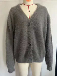 Detail of grey mink-like fuzzy V-neck knitted cardigan with button closure on mannequin