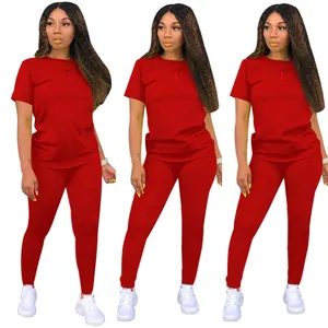 Close-up detail of solid red two-piece casual set featuring round neck top and leggings