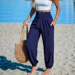 Women's loose navy blue beach joggers with a smocked high waist and elastic cuffs