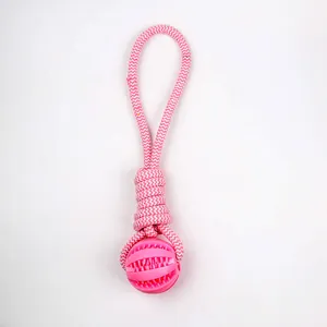 Detail of durable pink and white braided cotton rope dog chew toy with rubber ball