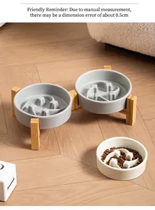 Detail view of ceramic slow feeder pet bowls with bamboo stand and meteor pattern.