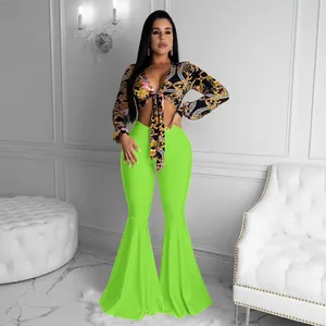 Close-up view of the sexy floral baroque crop top and neon green bell bottom pants