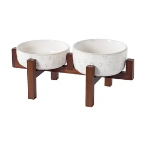 Double elevated ceramic pet bowl set with embossed paw print design and wood stand