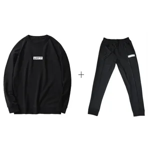 Detailed view of the black sweatshirt and sweatpants tracksuit set with logo print.