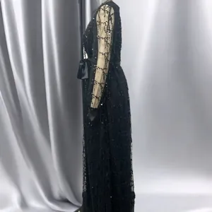 Detailed side view of a black mesh evening dress with elegant sequin embellishments