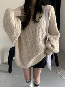 Dettaglio ravvicinato di un maglione a trecce color crema con scollo a V alla moda