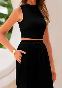 Detail view of women's black 2-piece ribbed knit sleeveless top and wide-leg trousers.