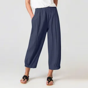 Loose dark blue cotton linen harem pants with high waist and cropped wide leg design.