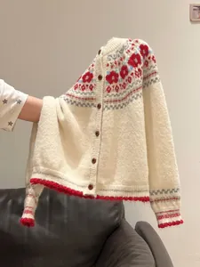 Close-up of retro Fair Isle knit cardigan with red pattern detail
