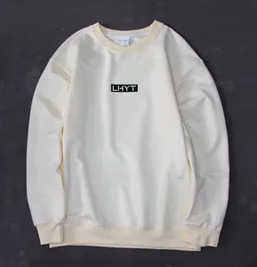 Detailed flat lay of a beige men's sports sweatshirt featuring black LHYT chest logo