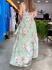 Rear view of a backless floral chiffon maxi dress with pink roses on light green