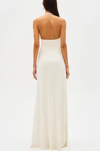 Back view of a minimalist white halter maxi dress with an elegant backless design