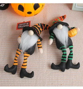 Detailed view of two handmade Halloween gnomes with decorative long striped legs