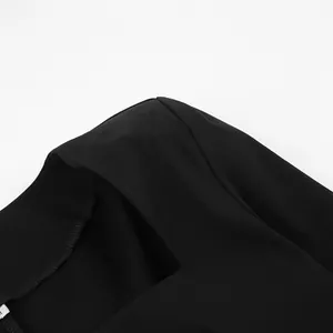 Close-up detail of the square neckline and shoulder seam of a French style black dress