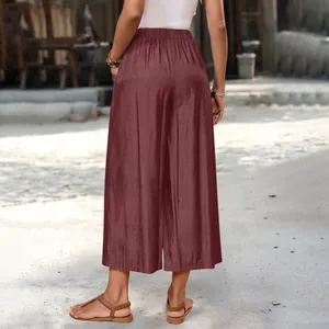 Back view of women's loose wide-leg cropped pants with pockets in burgundy red color