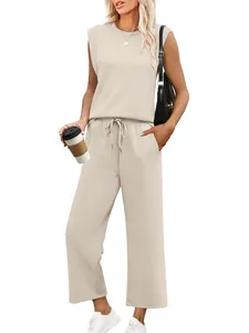 Full view of women's sleeveless round neck beige top and loose lounge pants set