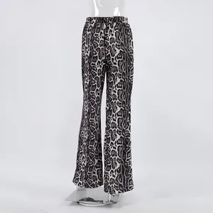 Close-up detail of high-waisted leopard print wide-leg trousers on a studio mannequin