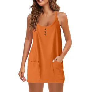 Detail view of women's orange sleeveless sundress featuring decorative buttons and pockets
