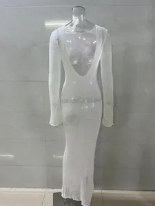 Back view detail of elegant sheer white knit maxi dress with a deep V open back design