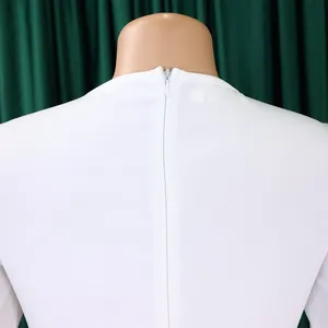 Close-up detail of the invisible zipper on the back of the elegant white office dress