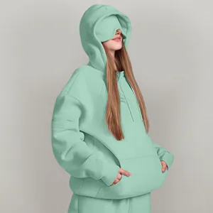 Detail shot of oversized mint green hoodie with built-in eye mask and kangaroo pocket