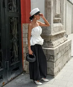 Chic white strapless tube top with ruffled peplum hem for a high-fashion summer look