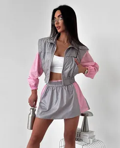 Full view of women's grey and pink color-block zip-up jacket and matching skirt set.