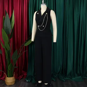 Elegant black sleeveless jumpsuit featuring a blazer collar and a decorative gold chain detail